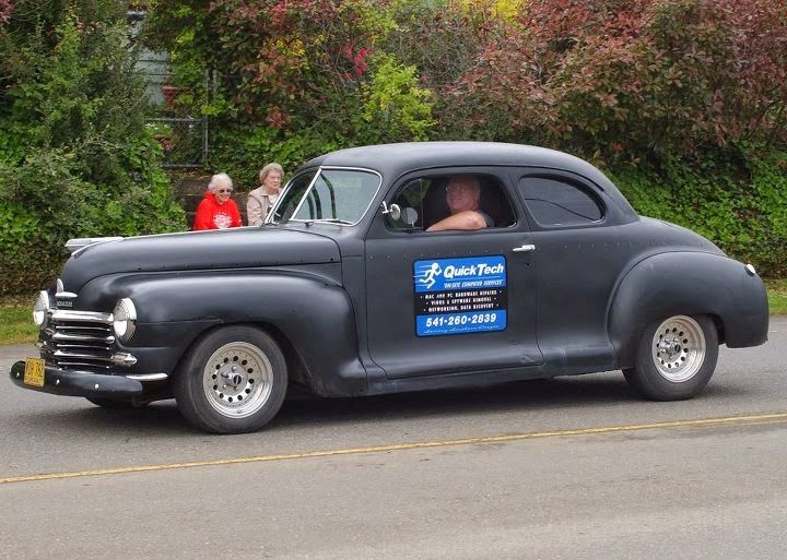 Dale Barrett's iCompute on-site computer service car, signed with the phone number, driving through Coos Bay, Oregon